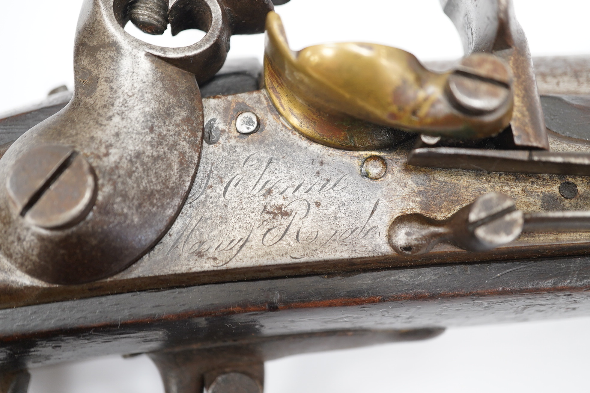 An 18mm French military flintlock musket, lock engraved St. Etienne Manufre Royale, regulation lock with brass pan, iron barrel and regulation iron mounts, with steel rammer. Condition - fair